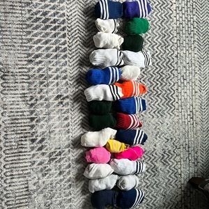 27 pairs of soccer socks, some never worn, some slightly worn